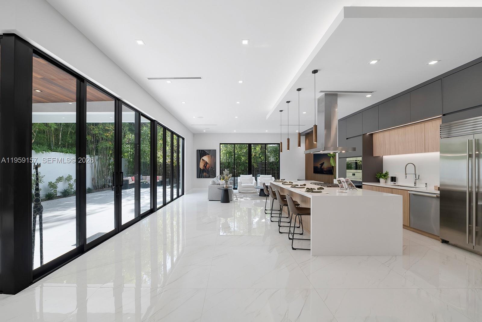 1780 Chucunantah Road Miami, FL 33133 - Photo 12 of 34 a view of a kitchen with kitchen island wooden floor a large window and stainless steel appliances