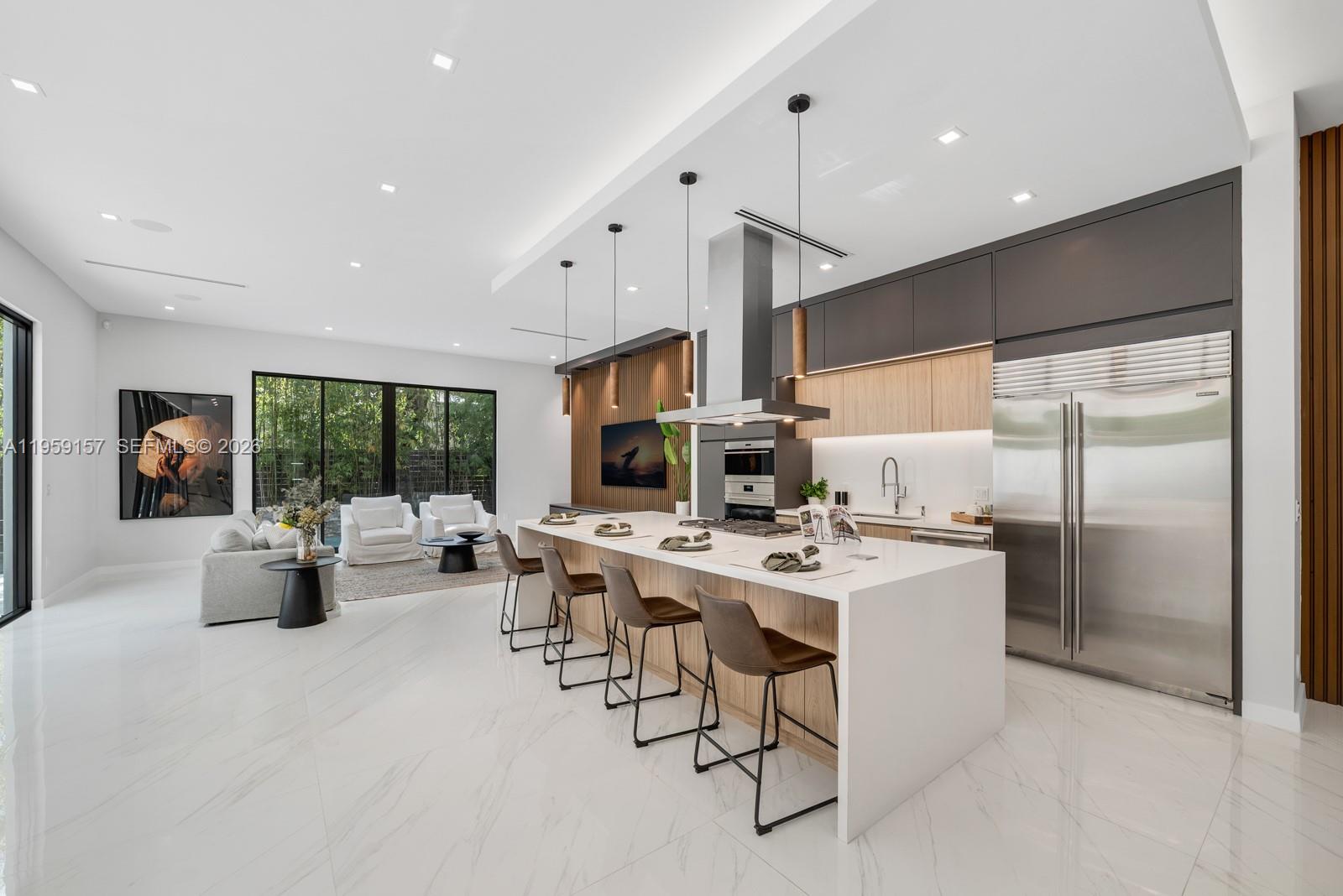1780 Chucunantah Road Miami, FL 33133 - Photo 13 of 34 a living room with stainless steel appliances furniture a rug and a view of kitchen