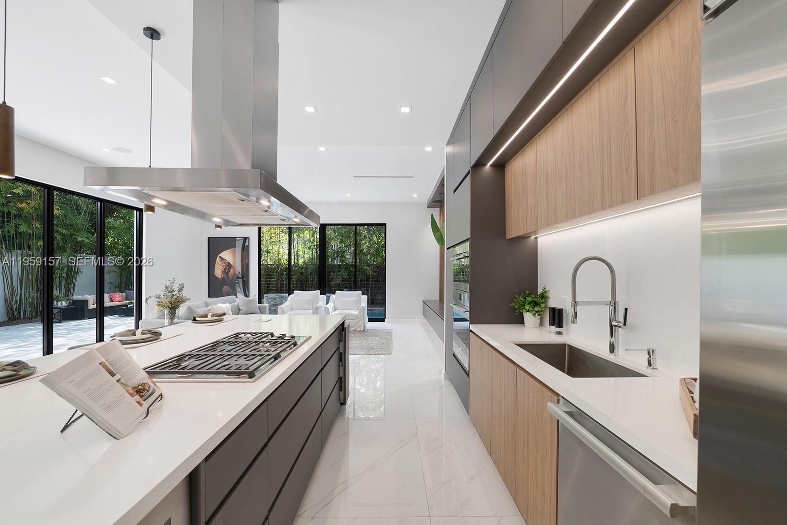 1780 Chucunantah Road Miami, FL 33133 - Photo 14 of 34 a large kitchen with a large window and stainless steel appliances