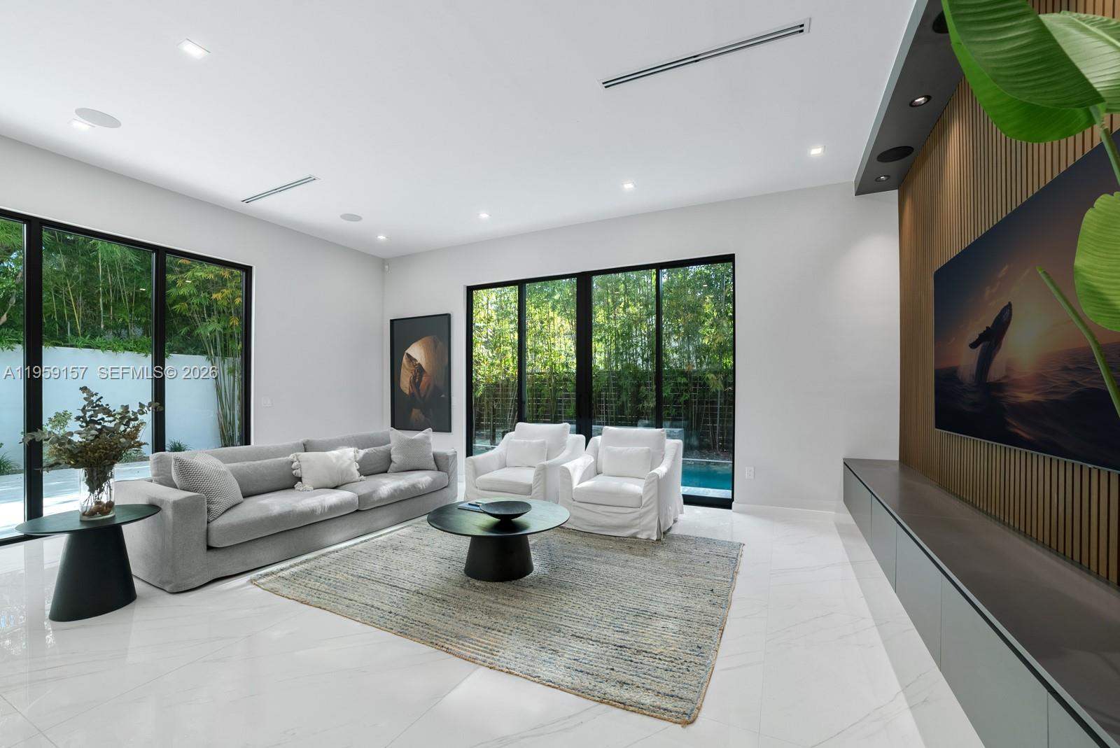 1780 Chucunantah Road Miami, FL 33133 - Photo 15 of 34 a living room with furniture and large windows