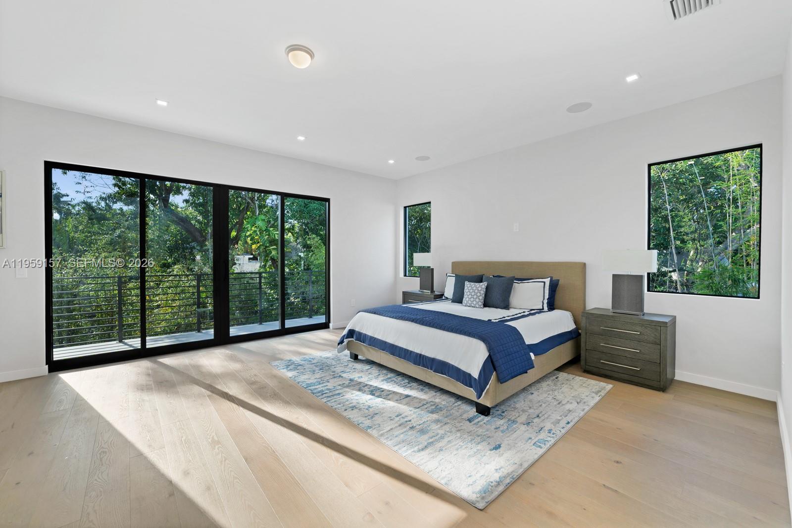 1780 Chucunantah Road Miami, FL 33133 - Photo 22 of 34 a spacious bedroom with a large bed and a large window