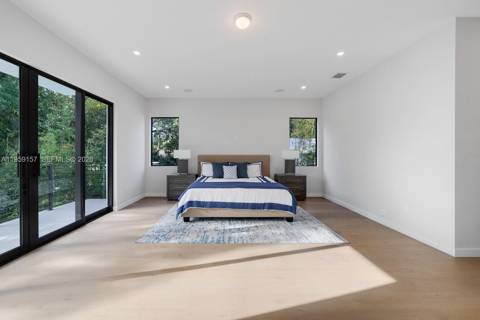 1780 Chucunantah Road Miami, FL 33133 - Photo 23 of 34 a spacious bedroom with a bed and large window