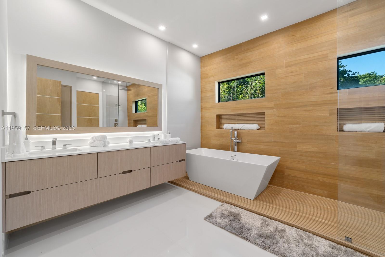 1780 Chucunantah Road Miami, FL 33133 - Photo 25 of 34 a bathroom with a sink mirror and a bathtub