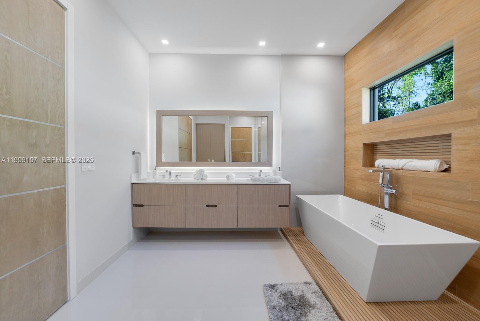 1780 Chucunantah Road Miami, FL 33133 - Photo 26 of 34 a bathroom with a tub sink and mirror