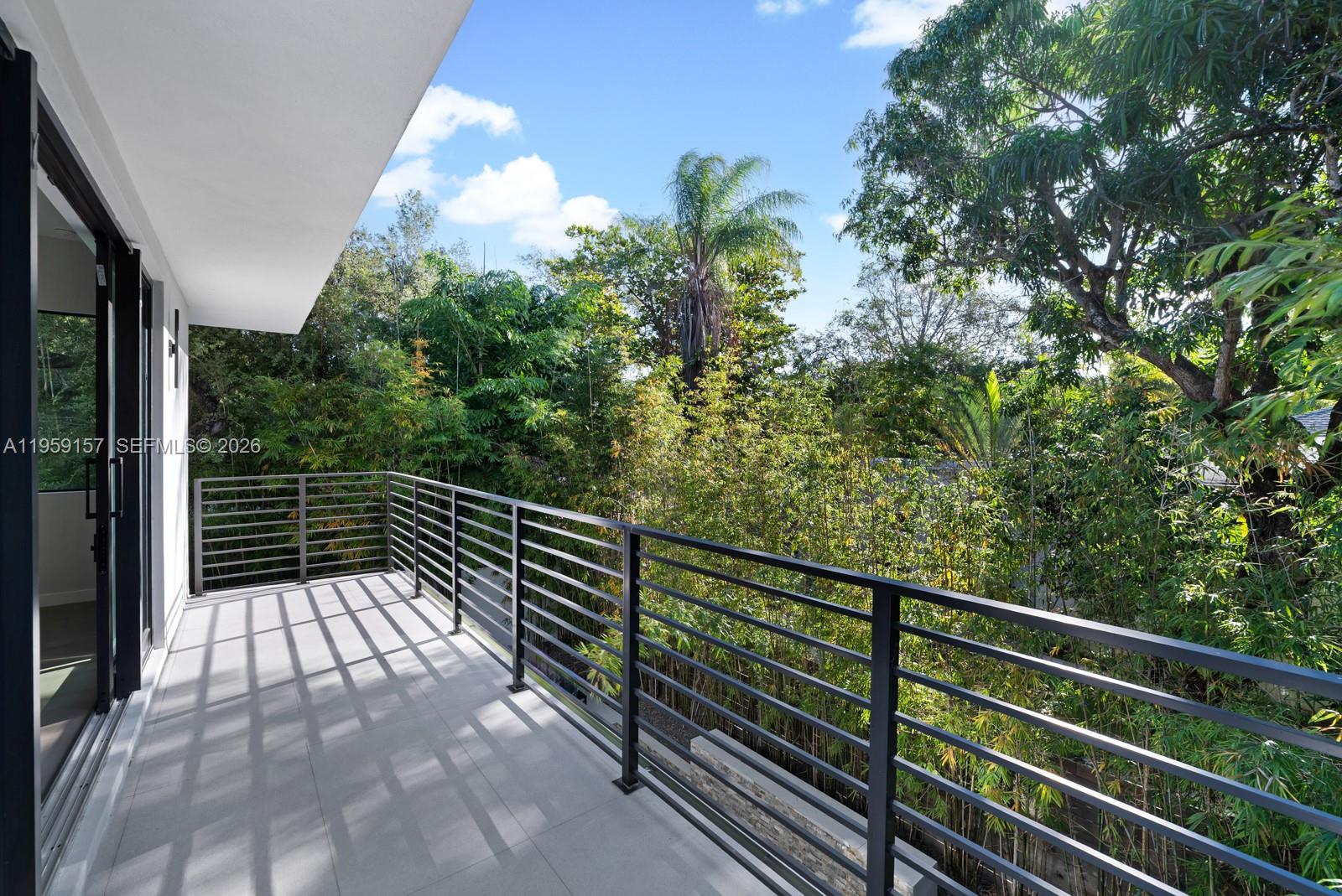 1780 Chucunantah Road Miami, FL 33133 - Photo 29 of 34 a view of balcony with wooden floor and fence