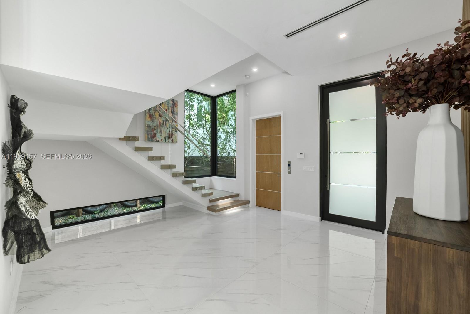 1780 Chucunantah Road Miami, FL 33133 - Photo 4 of 34 a spacious bedroom with a bed and a couch