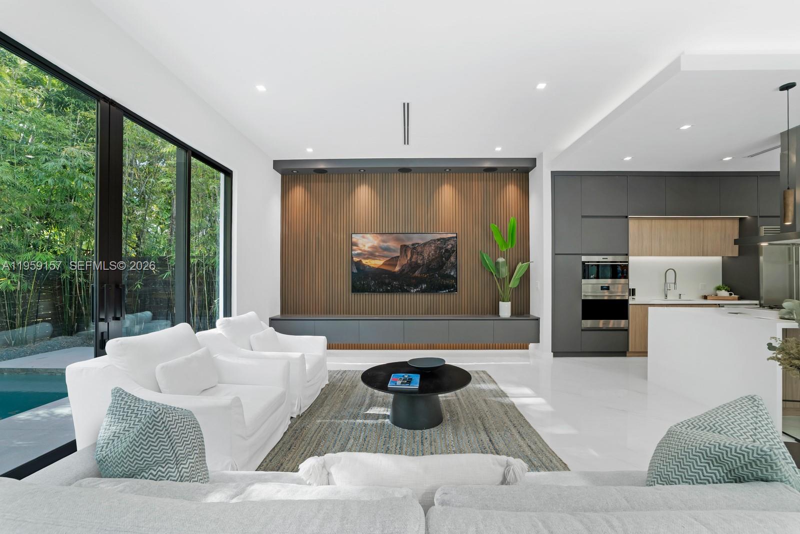 1780 Chucunantah Road Miami, FL 33133 - Photo 10 of 34 a living room with fireplace furniture and a large window