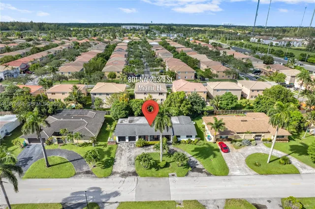 an aerial view of residential houses and outdoor space