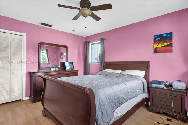 a bedroom with a bed and a dresser