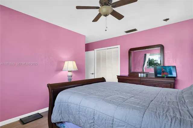 a bedroom with pink walls and bed