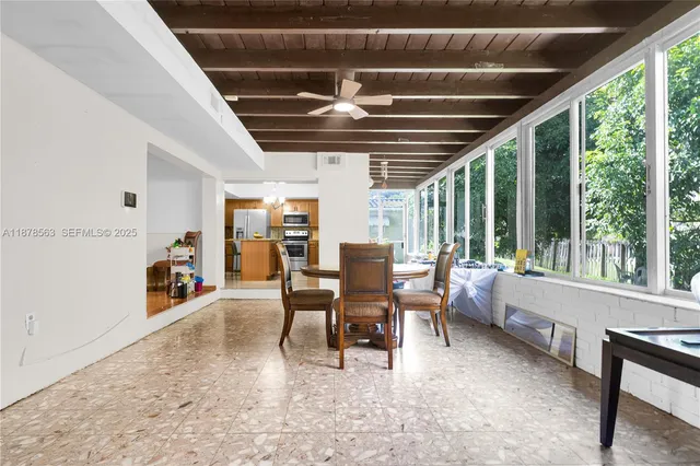 a dining room with furniture water view and a large window