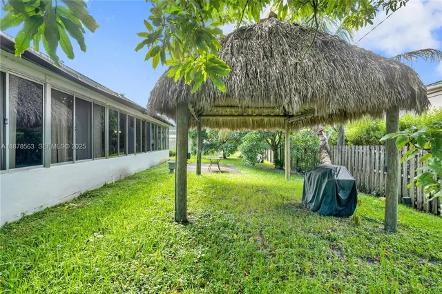 a backyard of a house with barbeque oven