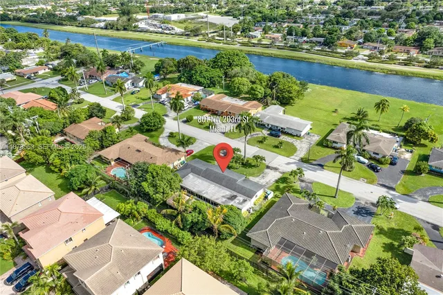 an aerial view of lake residential houses with outdoor space and swimming pool