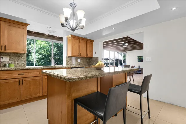 a kitchen with stainless steel appliances granite countertop a sink a stove and a refrigerator