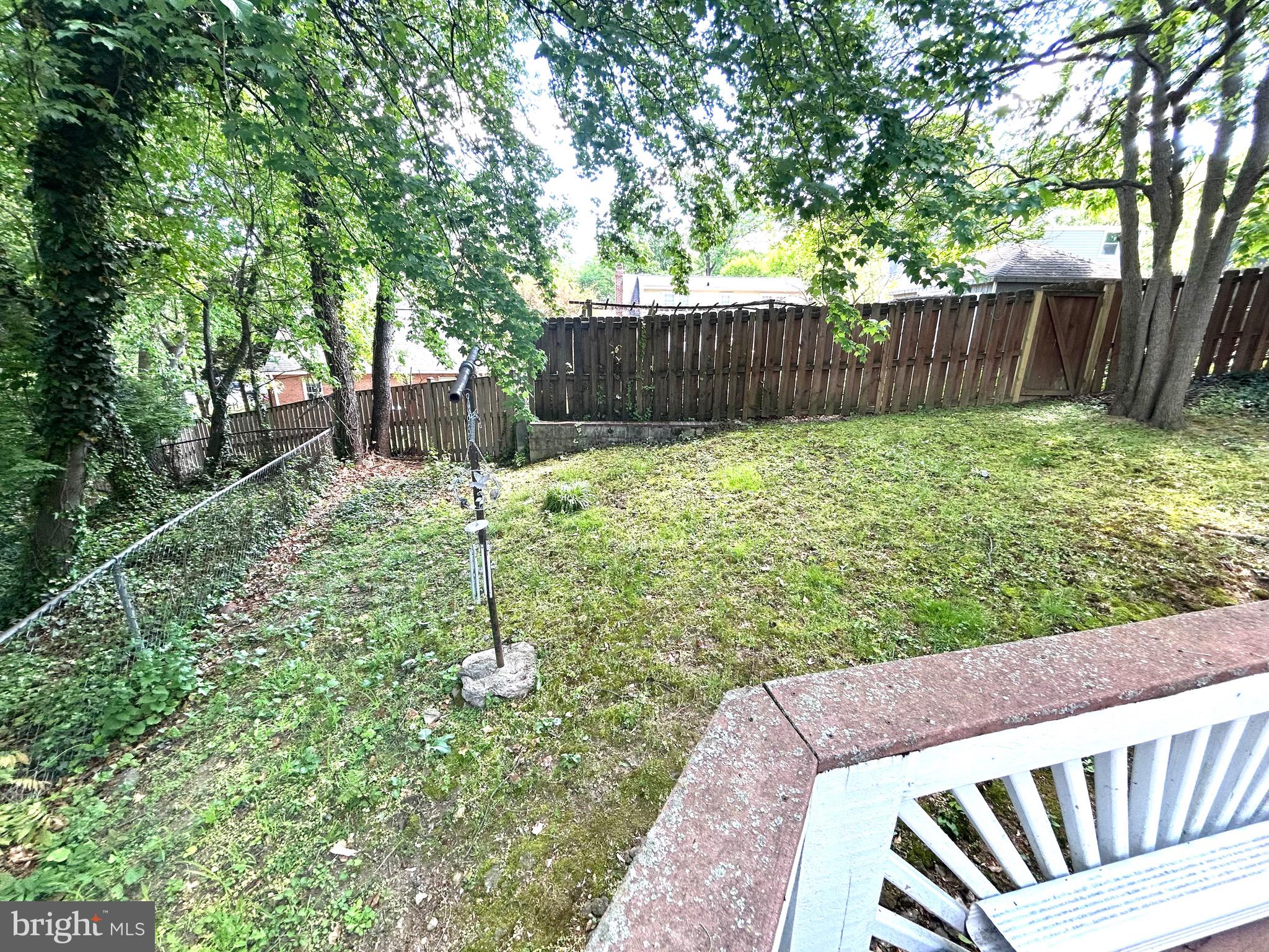 906 Dryden Court Silver Spring, MD 20901 - Photo 7 of 12 a view of a backyard with wooden fence and a large tree