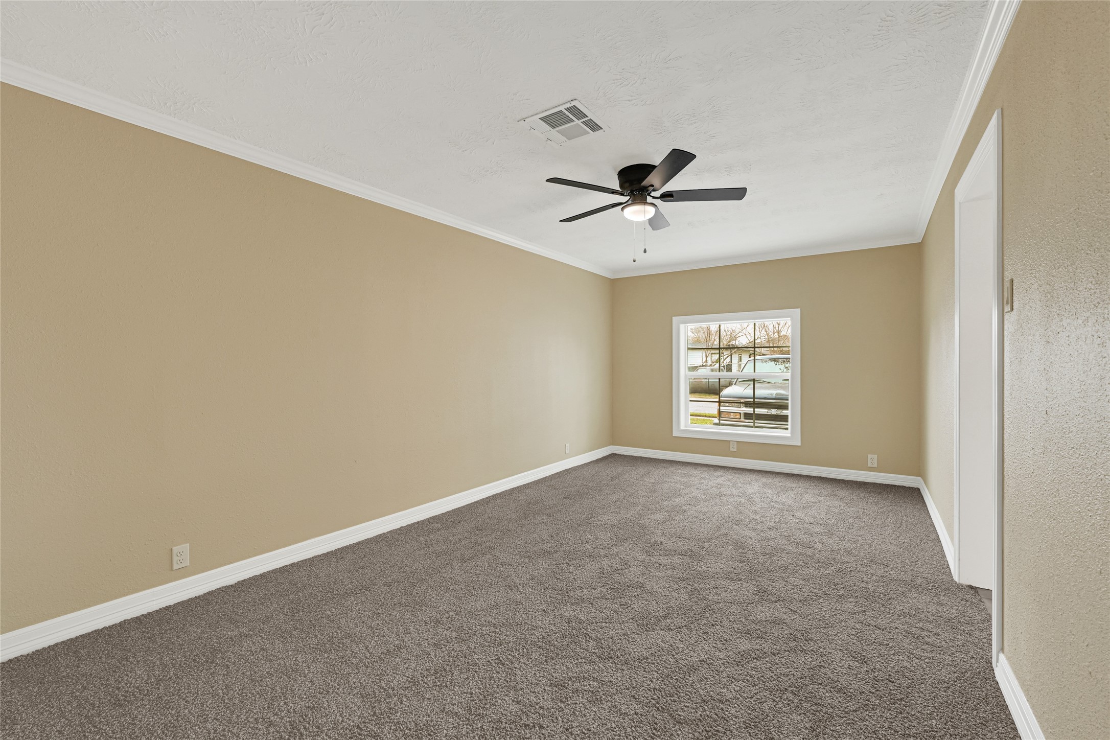 8526 Vennard Road Houston, TX 77034 - Photo 15 of 22 an empty room with a window and a ceiling fan