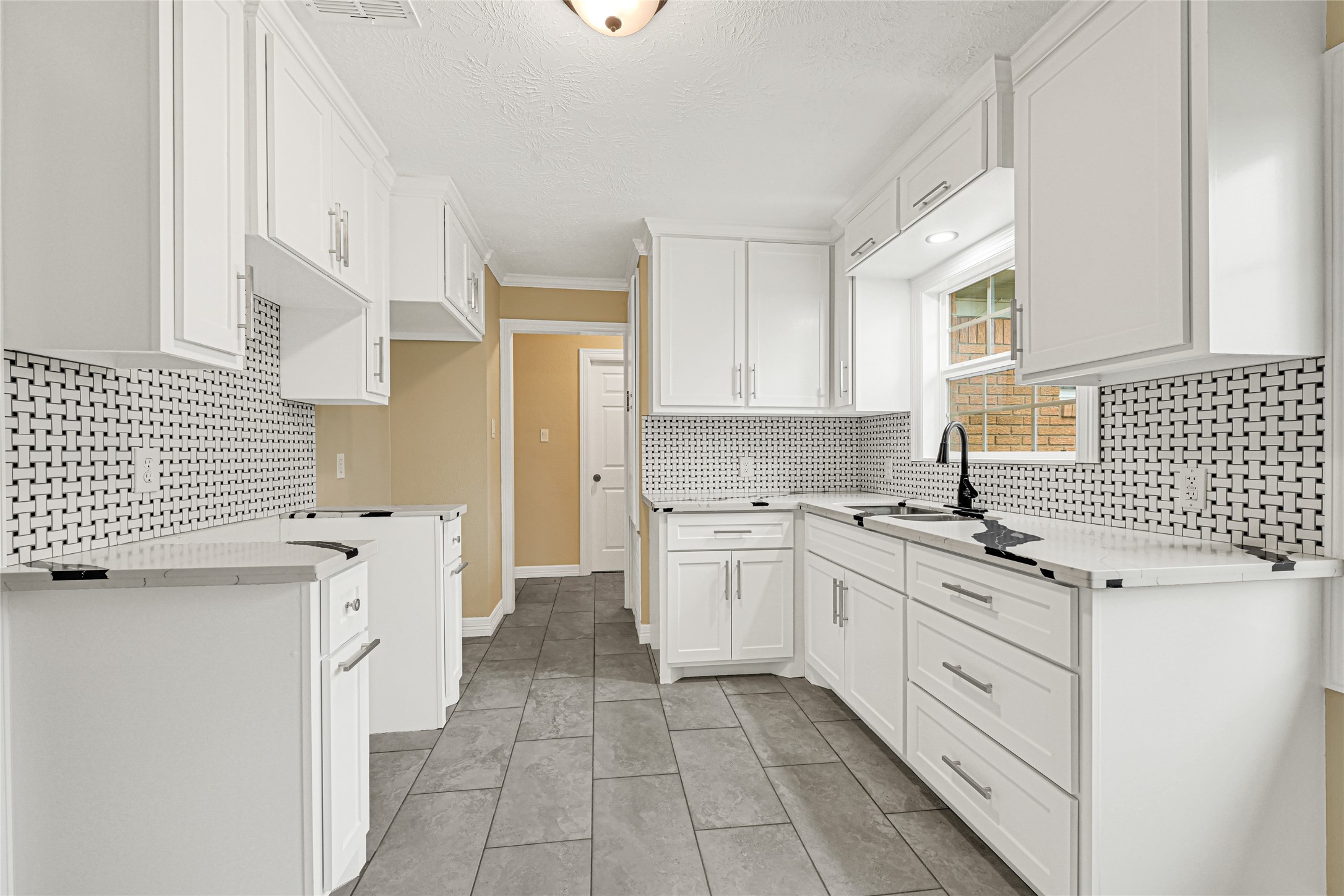 8526 Vennard Road Houston, TX 77034 - Photo 7 of 22 a kitchen with a stove a sink and a refrigerator