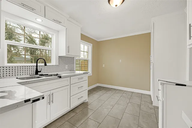 a kitchen with a sink cabinets and window