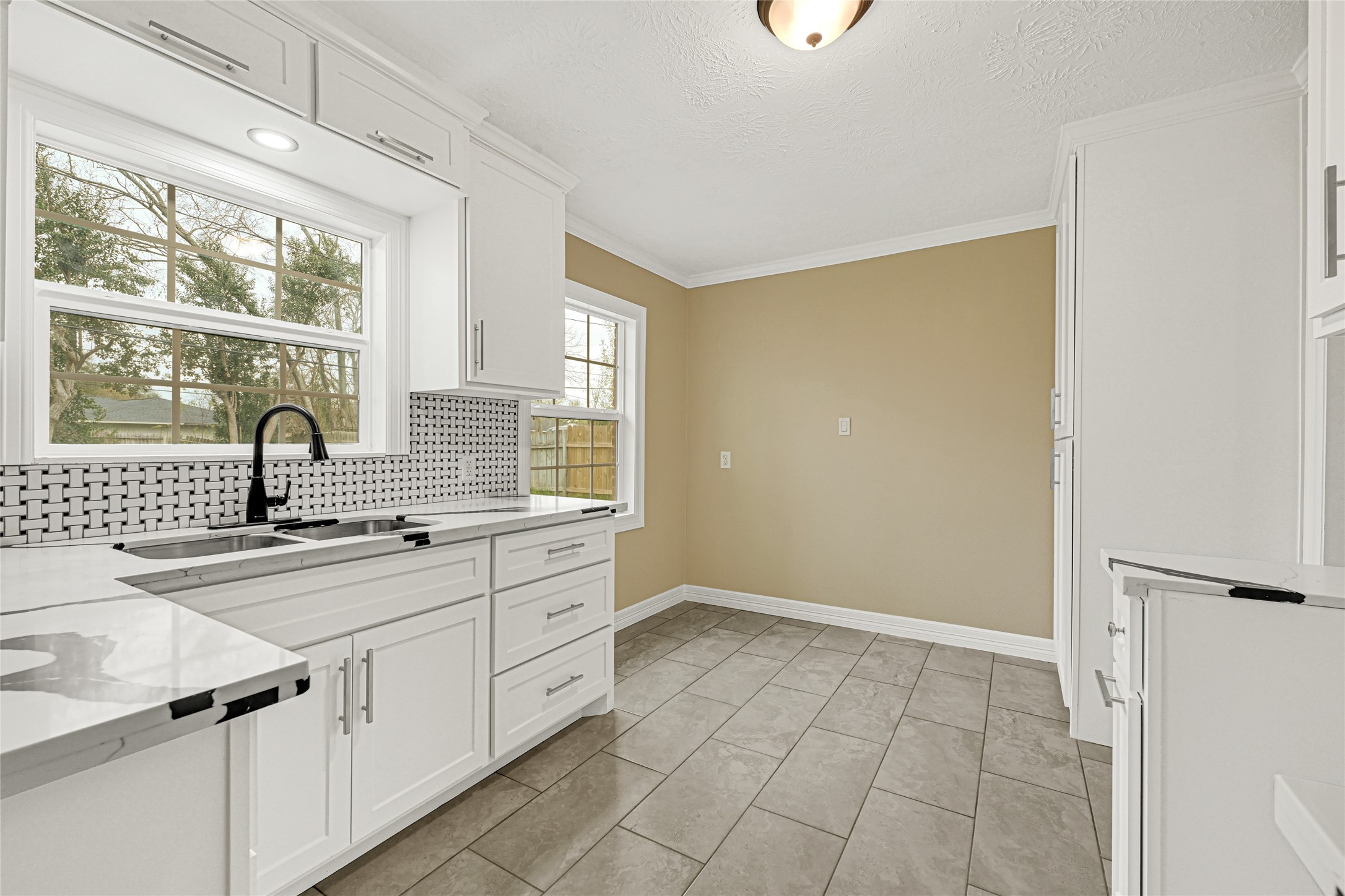 8526 Vennard Road Houston, TX 77034 - Photo 8 of 22 a kitchen with a sink cabinets and window