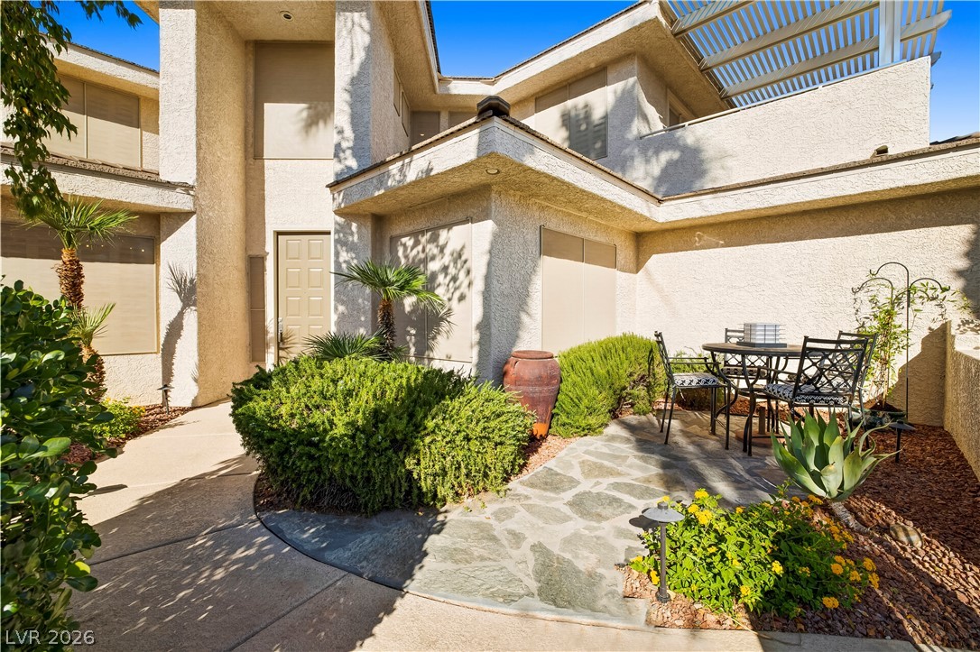 1135 Calico Ridge Drive Henderson, NV 89011 - Photo 6 of 86 A welcoming stone path leads to a private courtyard, perfect for outdoor relaxation.