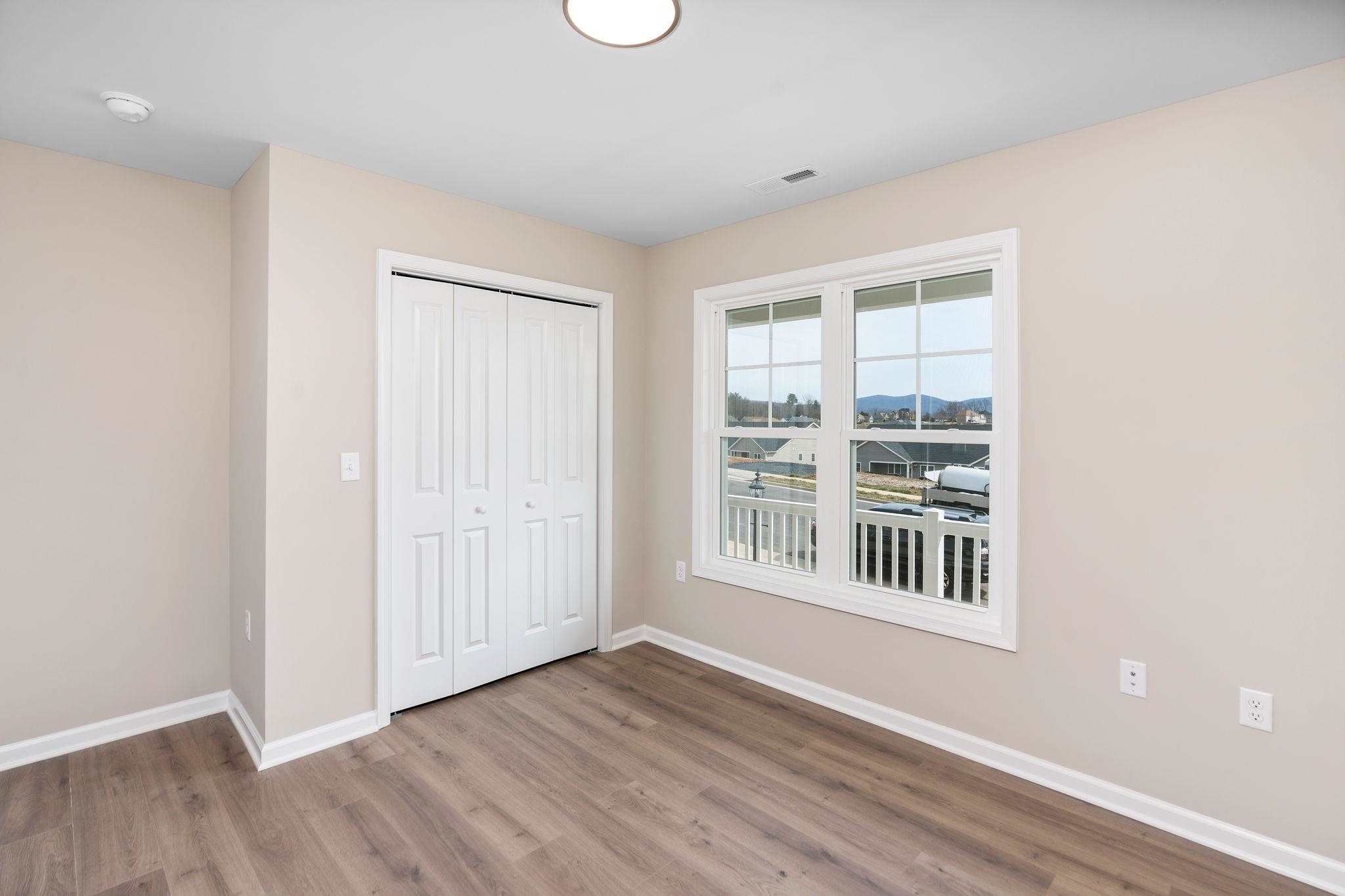 205 Spring Run Lane Waynesboro, VA 22980 - Photo 24 of 35 an empty room with wooden floor and windows