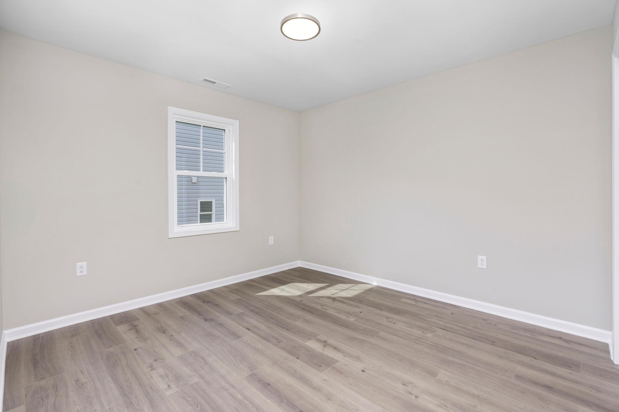 205 Spring Run Lane Waynesboro, VA 22980 - Photo 25 of 35 an empty room with wooden floor and windows