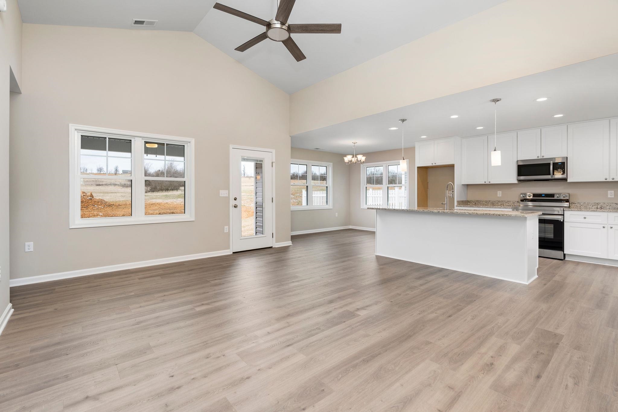 205 Spring Run Lane Waynesboro, VA 22980 - Photo 5 of 35 an open kitchen with kitchen island wooden floors and stainless steel appliances