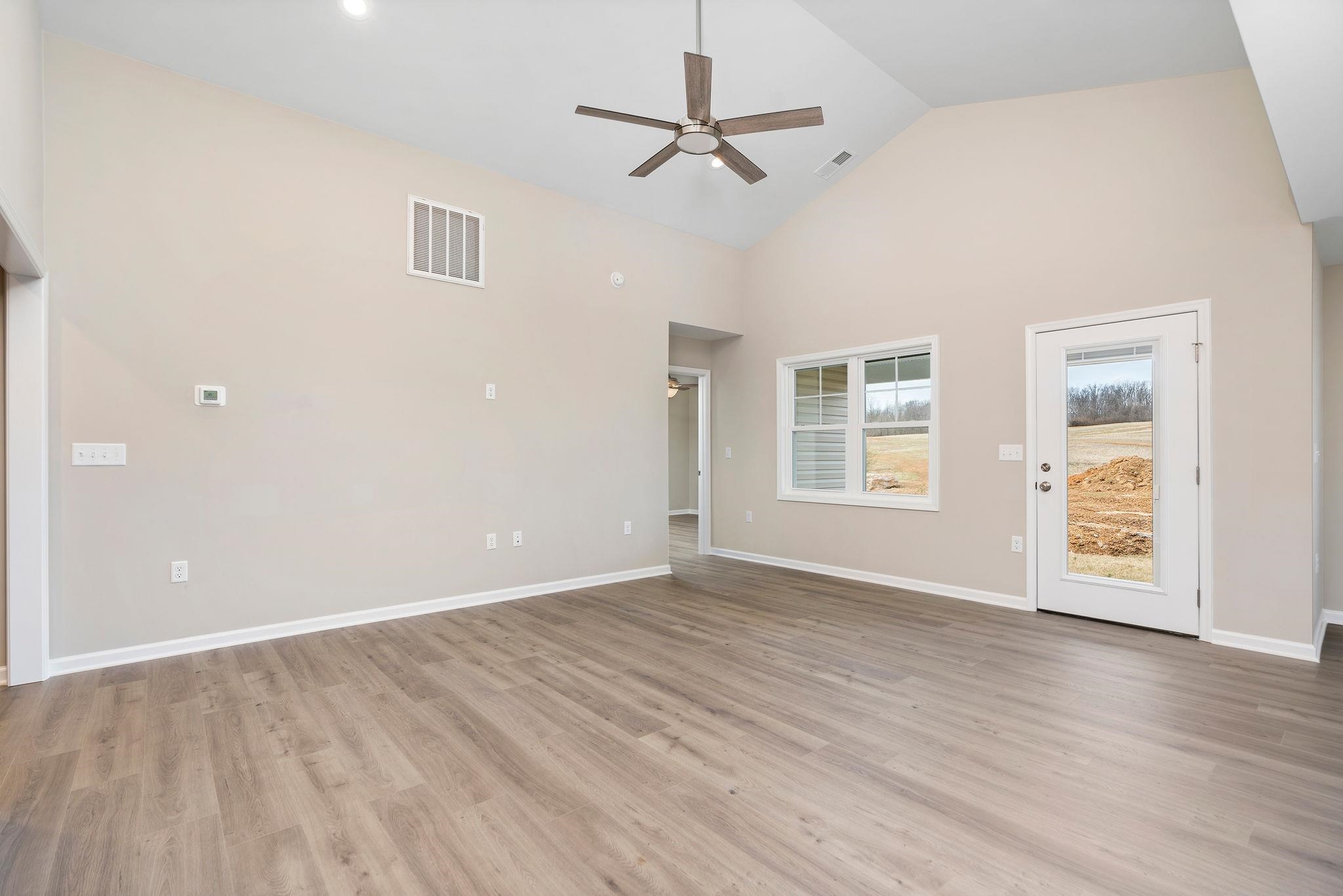 205 Spring Run Lane Waynesboro, VA 22980 - Photo 6 of 35 an empty room with wooden floor ceiling fan and windows