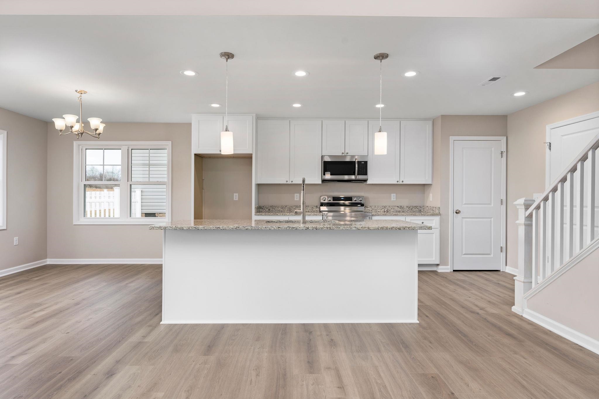 205 Spring Run Lane Waynesboro, VA 22980 - Photo 7 of 35 a kitchen with stainless steel appliances granite countertop a refrigerator a sink dishwasher a stove and white countertops with wooden floor