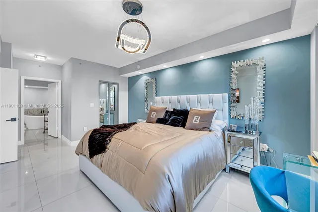 a bedroom with bed and a chandelier