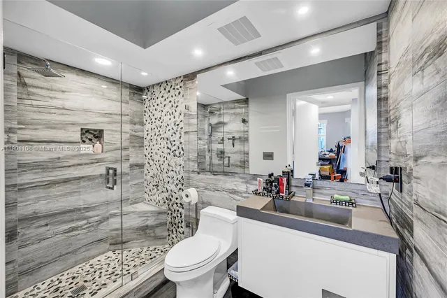 a bathroom with a sink toilet and shower
