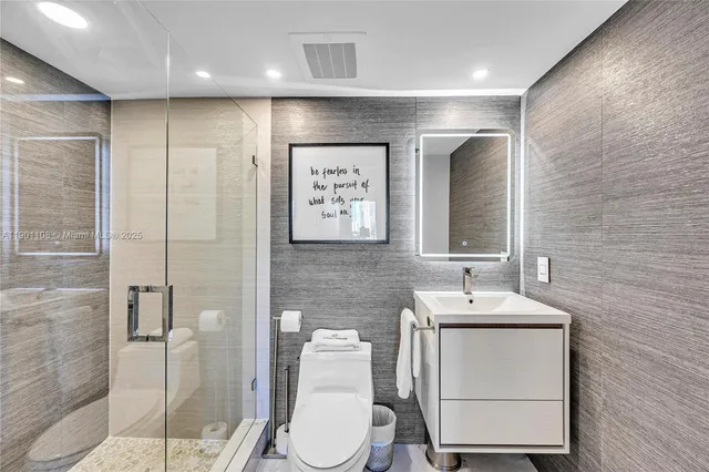 a bathroom with a toilet sink and shower