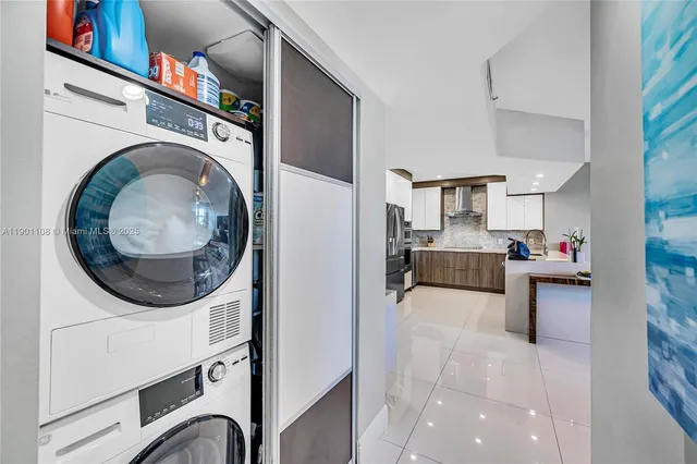 a view of a kitchen with furniture and a washer dryer
