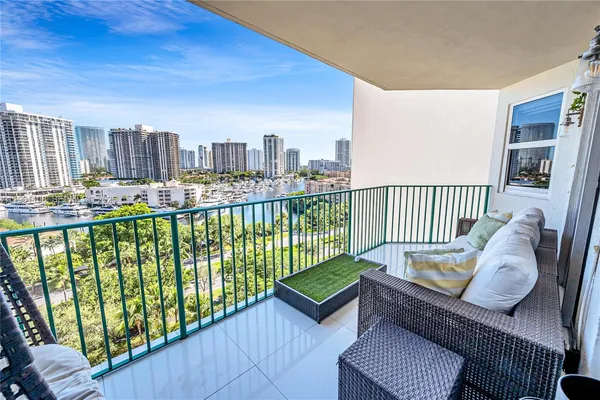 a balcony with furniture and a book shelf