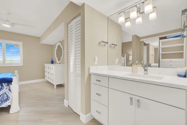 a bathroom with a sink vanity and a mirror