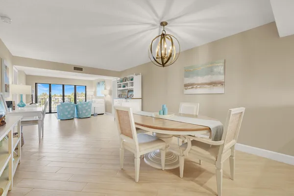 a kitchen with stainless steel appliances granite countertop a table and chairs