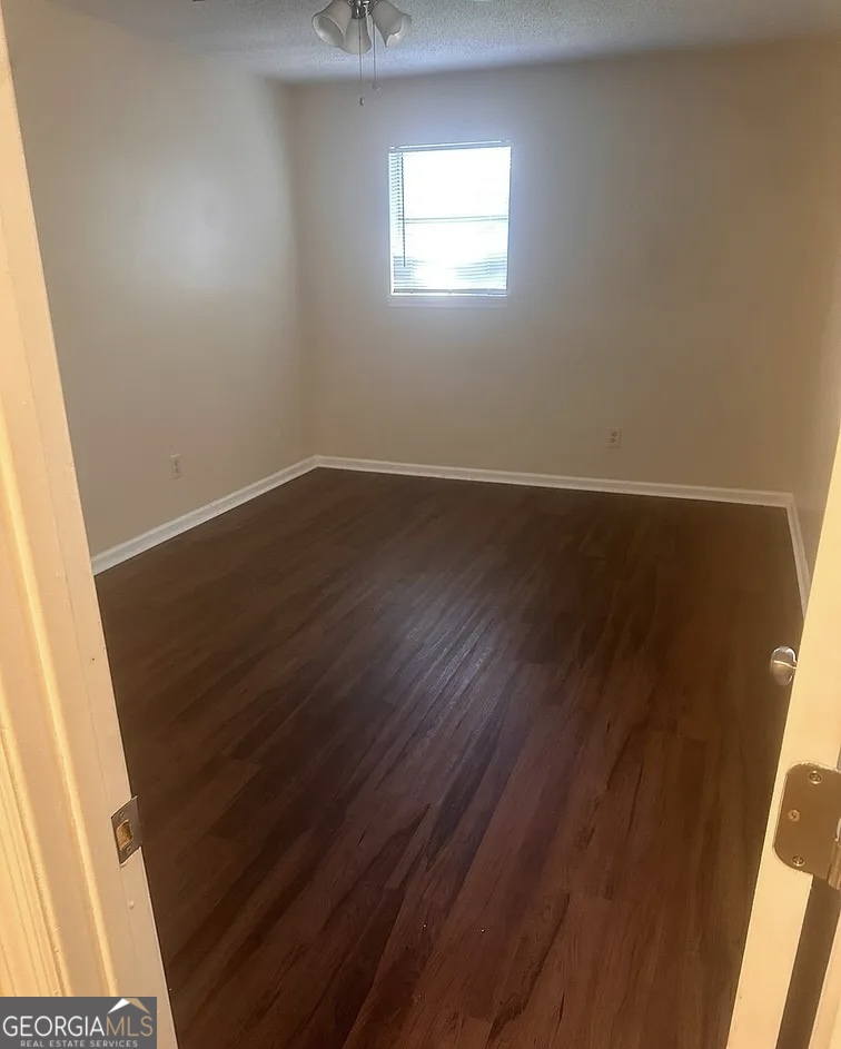 538 Southgate Avenue Albany, GA 31701 - Photo 12 of 16 an empty room with wooden floor and windows