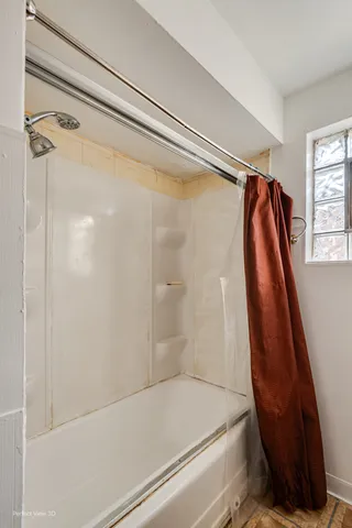 a bathroom with a shower and a tub