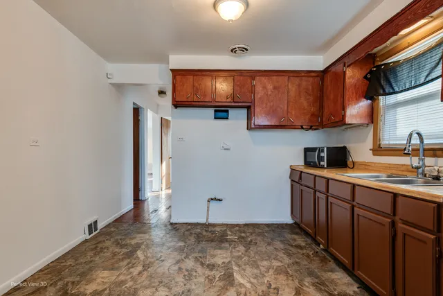 a kitchen with stainless steel appliances a sink stove and cabinets