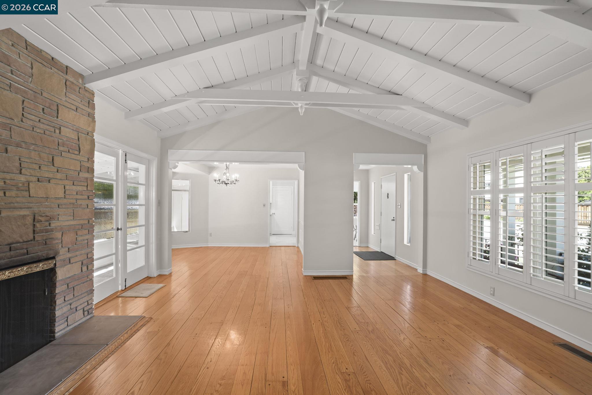 1051 San Rafael Street San Leandro, CA 94577 - Photo 4 of 26 a view of an empty room with wooden floor and a fireplace