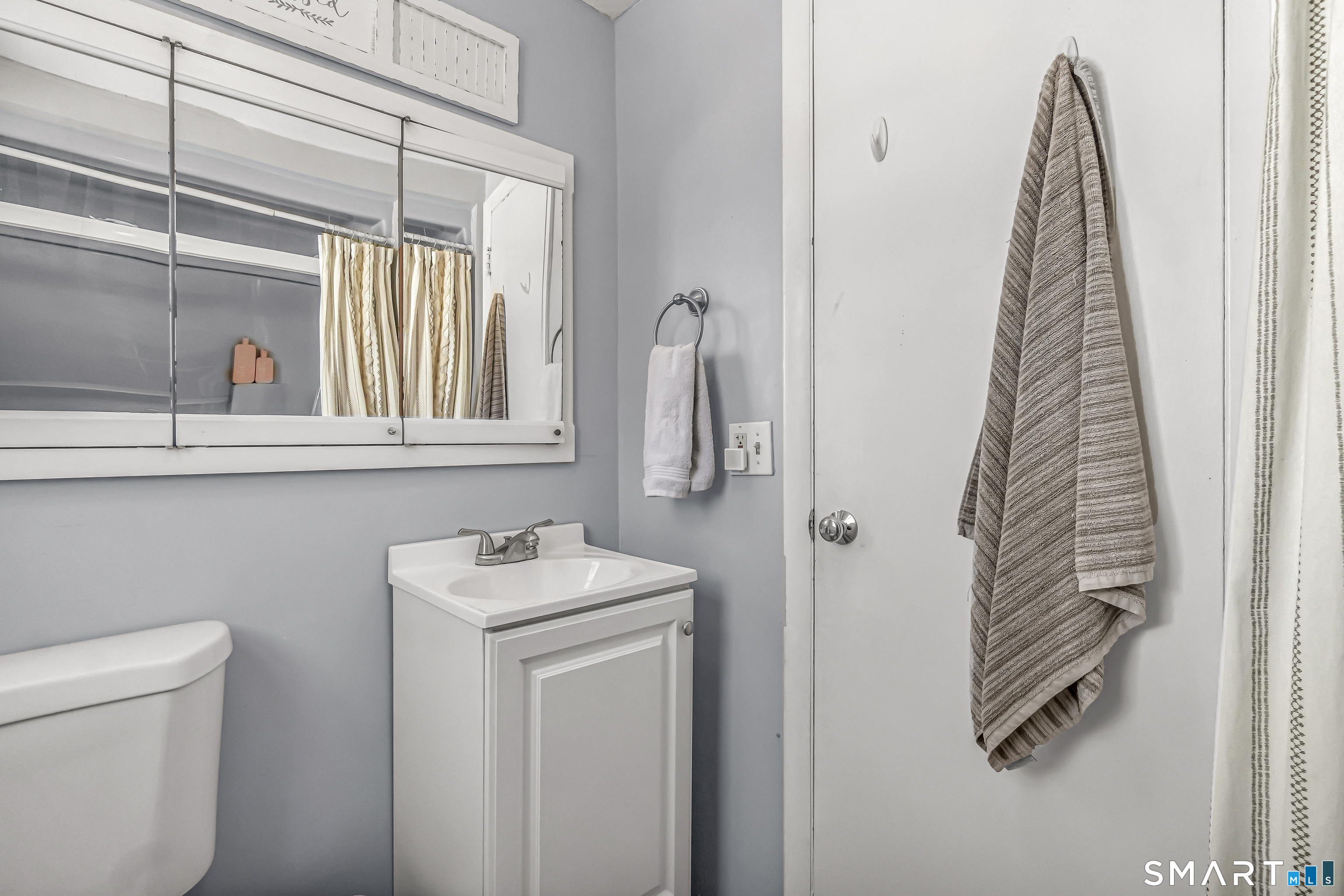 106 Hawley Avenue Milford, CT 06460 - Photo 13 of 39 a bathroom with a sink toilet and mirror