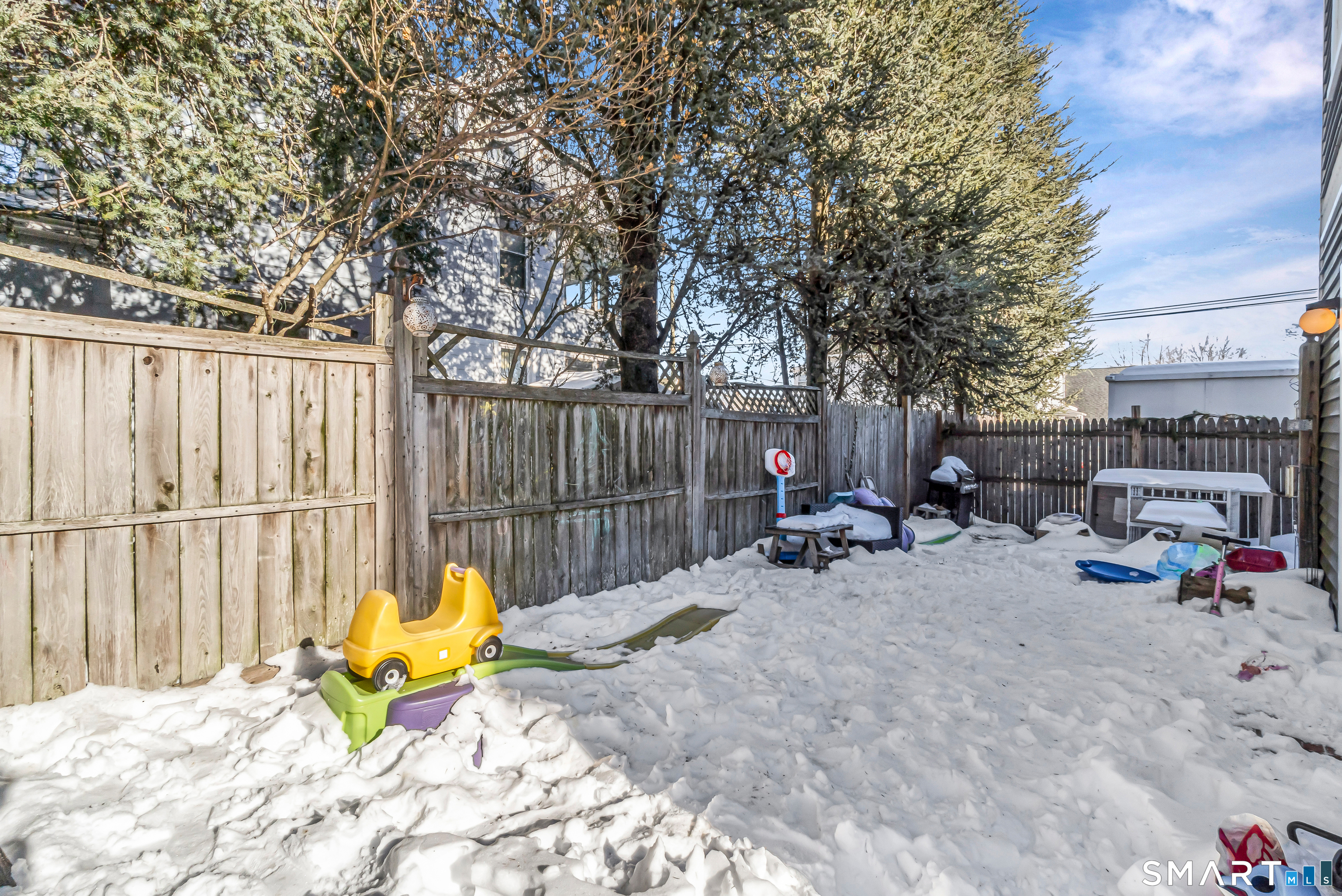 106 Hawley Avenue Milford, CT 06460 - Photo 20 of 39 a view of backyard with wooden fence and a large tree