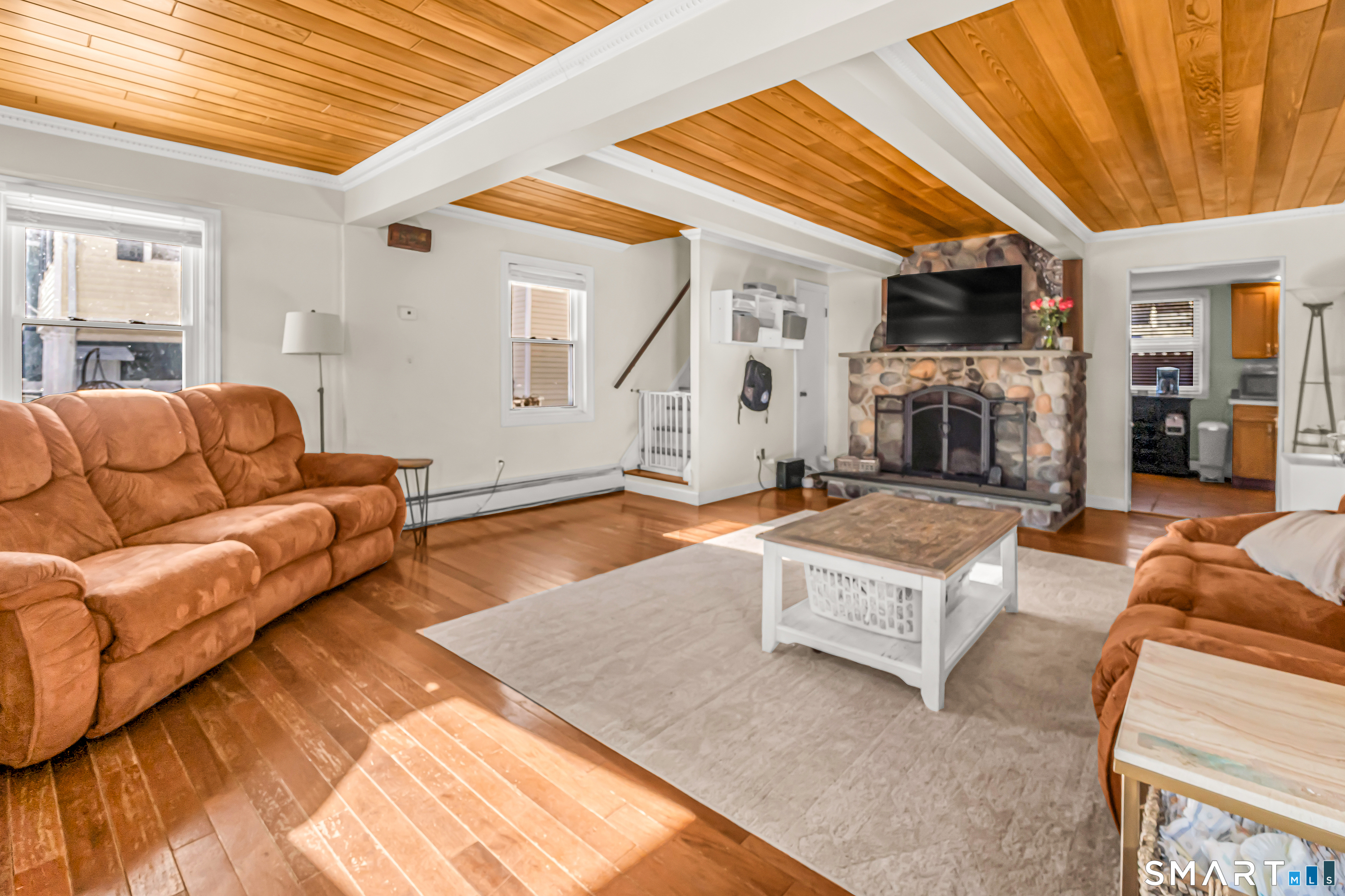 106 Hawley Avenue Milford, CT 06460 - Photo 30 of 39 a living room with furniture a flat screen tv and a table