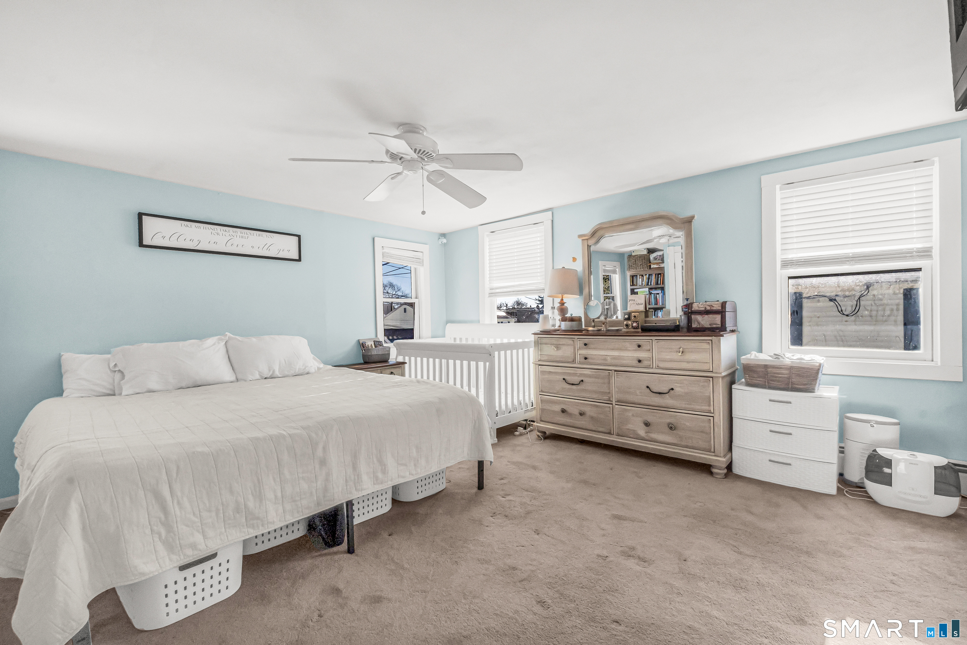 106 Hawley Avenue Milford, CT 06460 - Photo 3 of 39 a spacious bedroom with a bed and a table