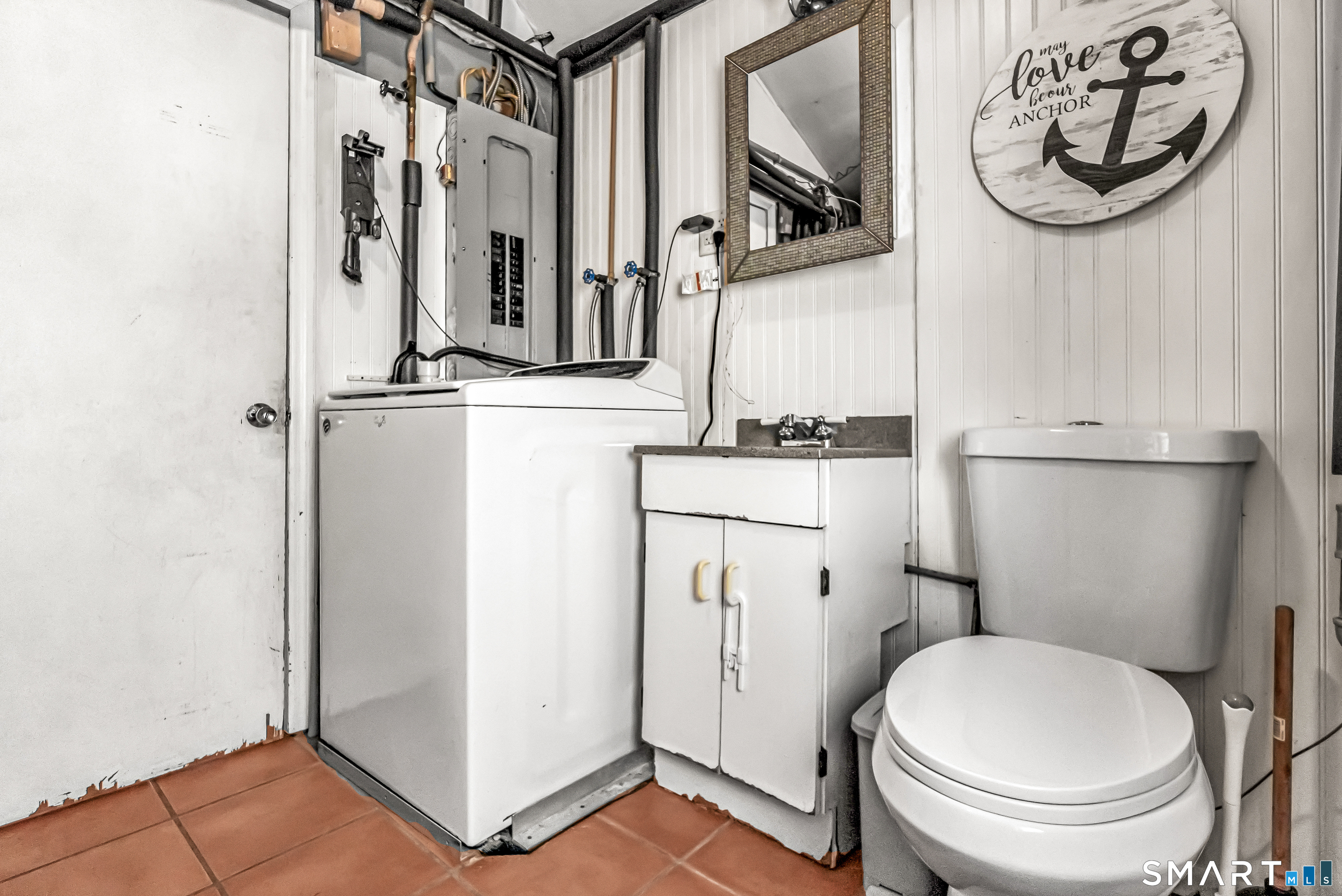 106 Hawley Avenue Milford, CT 06460 - Photo 38 of 39 a bathroom with a toilet a sink and a mirror