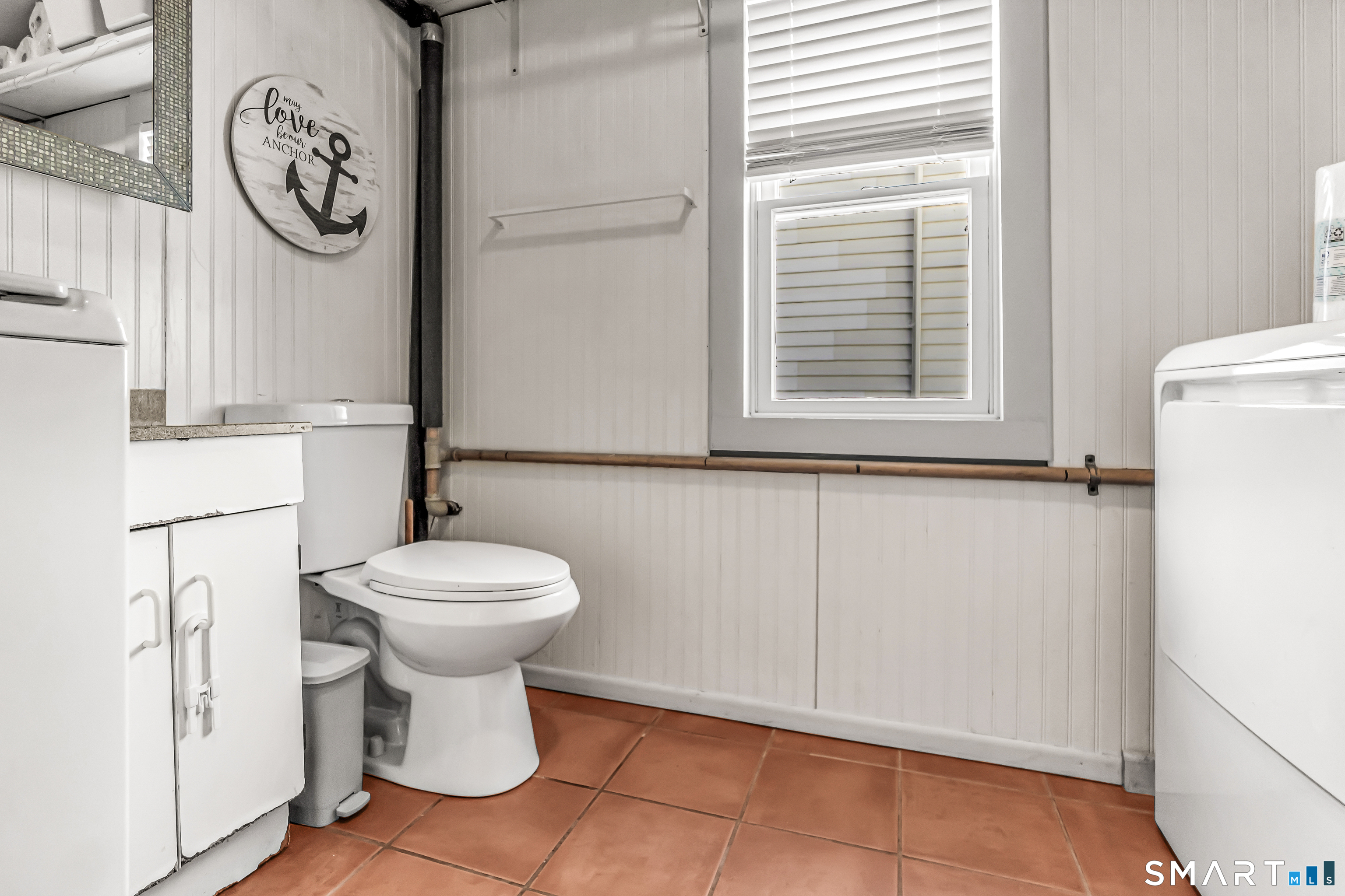 106 Hawley Avenue Milford, CT 06460 - Photo 39 of 39 a bathroom with a toilet and a shower curtain