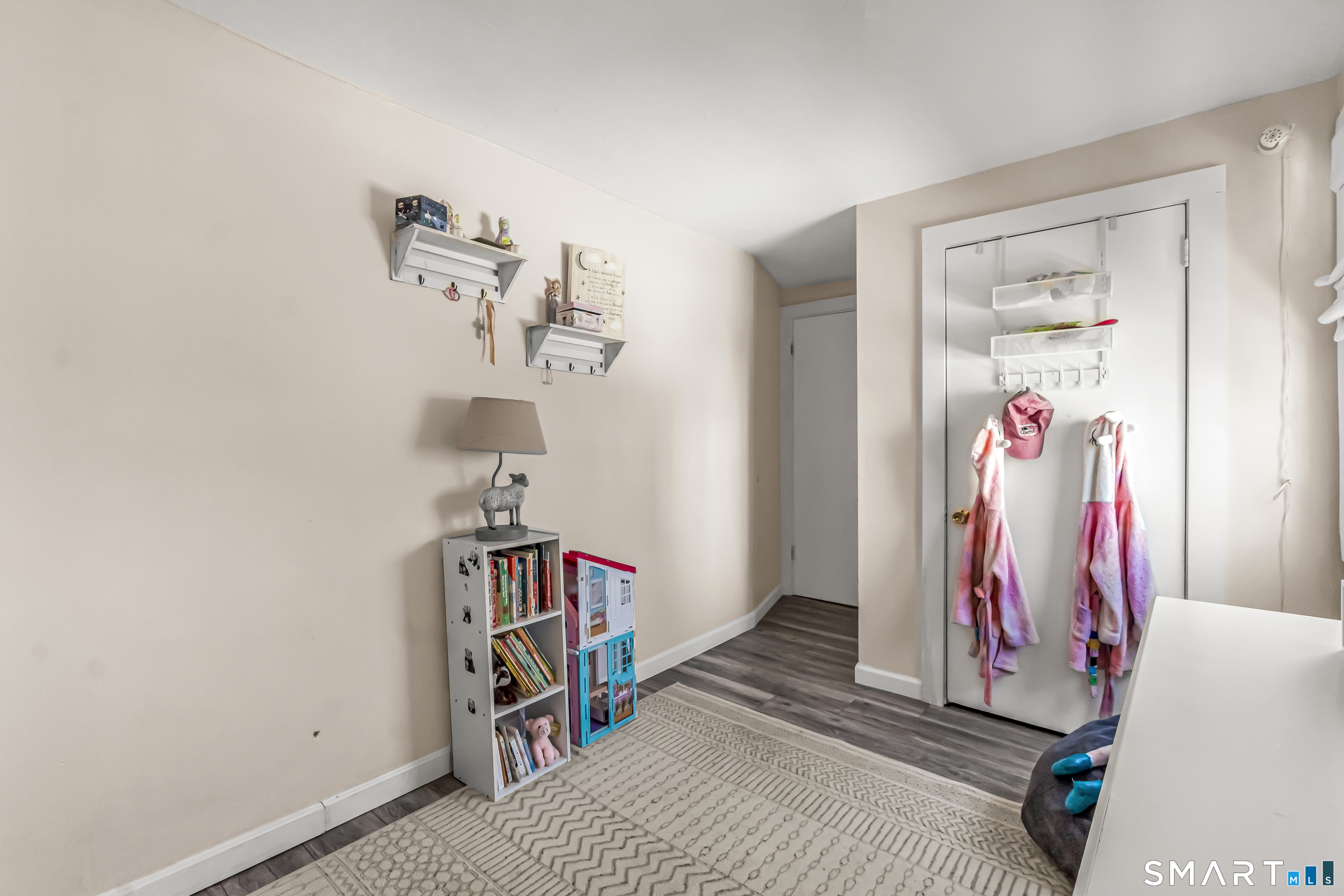 106 Hawley Avenue Milford, CT 06460 - Photo 8 of 39 a bedroom with a bed and a chandelier