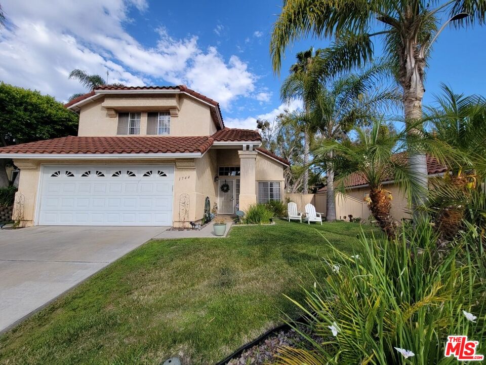1744 Crystal Ridge Way Vista, CA 92081 - Photo 1 of 20 a front view of a house with a garden and trees