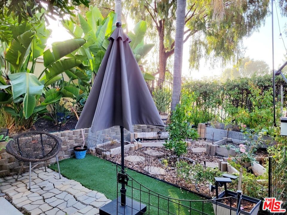 1744 Crystal Ridge Way Vista, CA 92081 - Photo 17 of 20 a view of a backyard with plants and a fountain