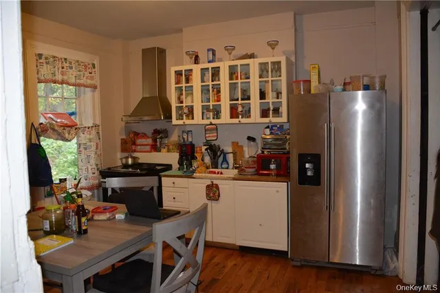 a kitchen with stainless steel appliances granite countertop a refrigerator and a stove top oven